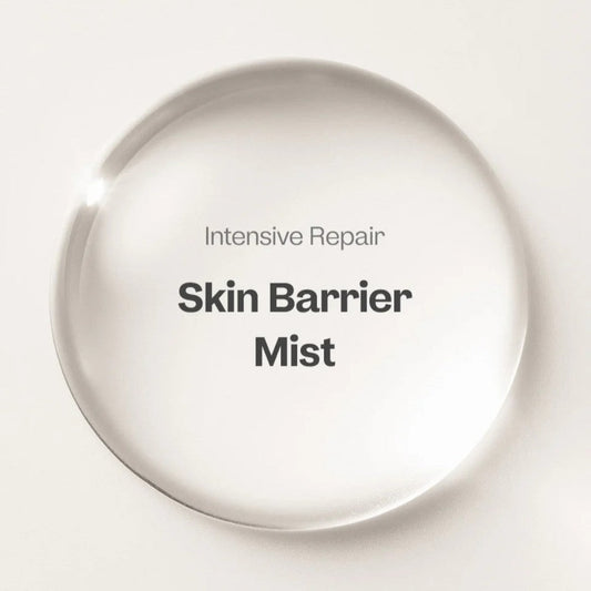 Intensive Repair Skin Barrier Mist in a clear round bottle displayed on a beige background.