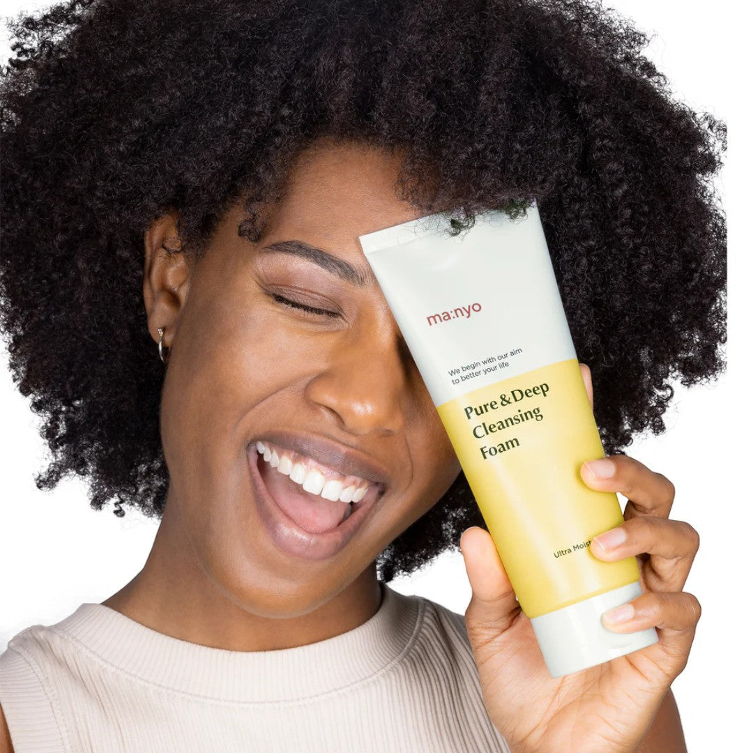 ma:nyo Pure&Deep Cleansing Foam 200ml held by a smiling woman with curly hair, showcasing the product.