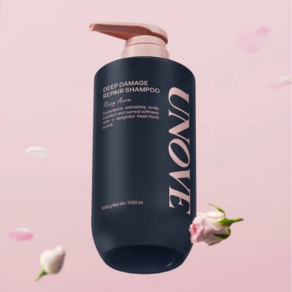 UNOVE Deep Damage Repair Shampoo in a matte navy blue bottle with a blush pink pump dispenser, set against a soft pink background with floating rose petals.