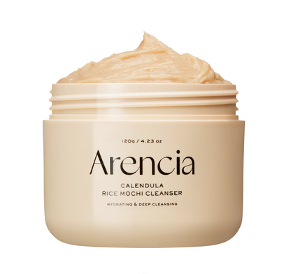 An open jar of Arencia Calendula Rice Mochi Cleanser showing the creamy beige cleanser inside, on a solid white background.