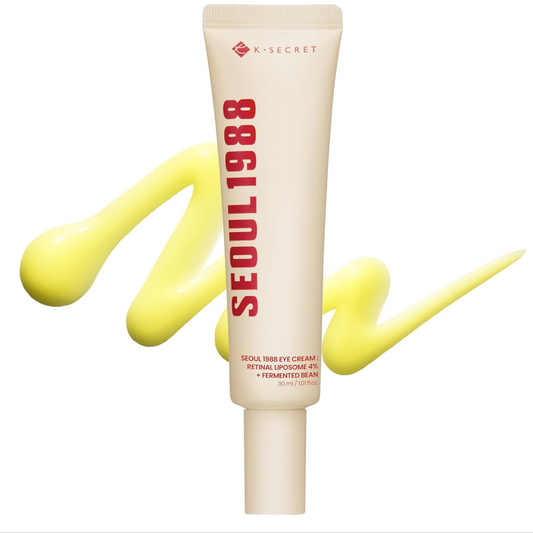A squeeze tube of Seoul 1988 Retinol Eye Cream by A-SECRET, shown on a white background with a bright yellow cream smear behind it.