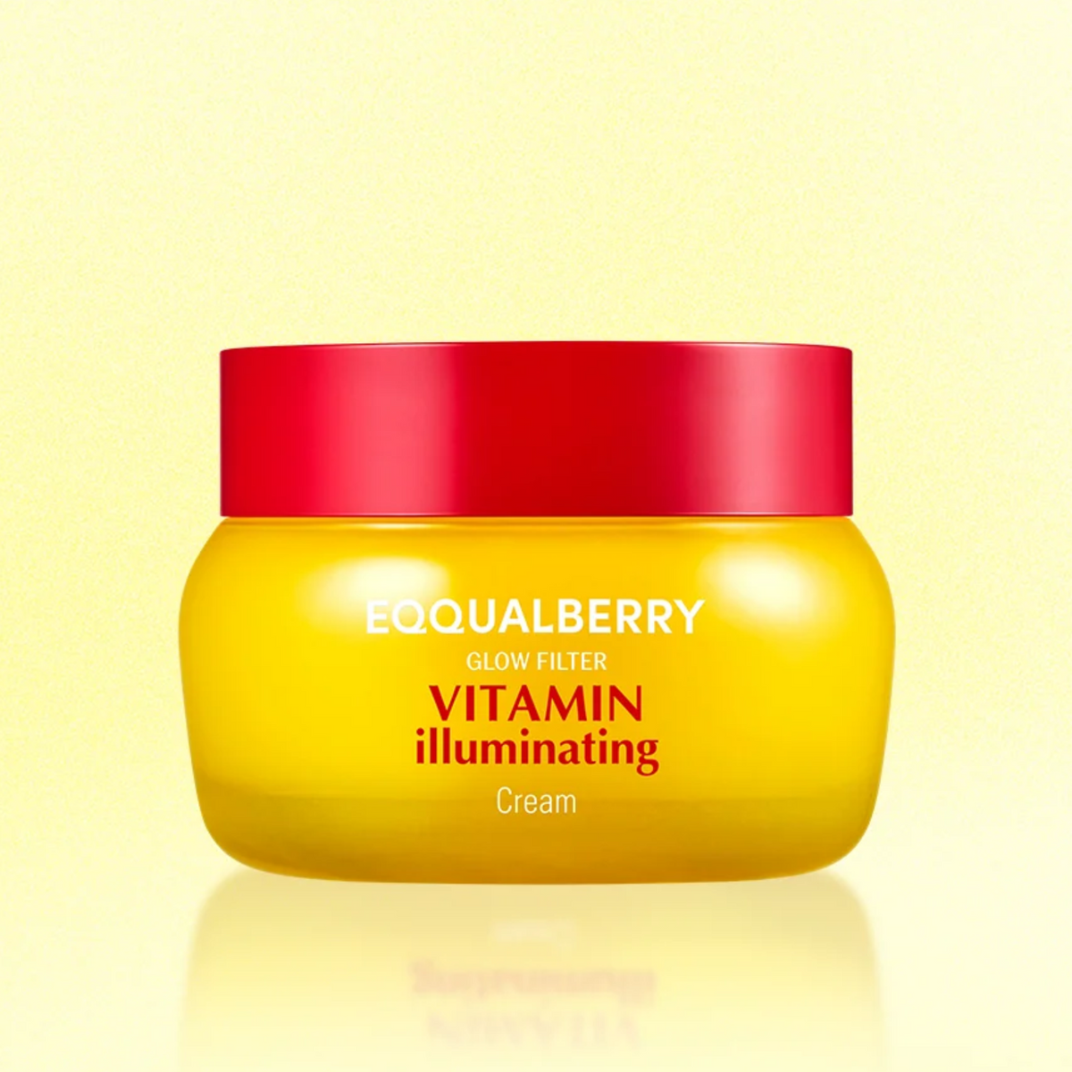 A jar of EQQUALBERRY Vitamin Illuminating Cream 50ml, featuring a bright yellow body and a vibrant red lid, set against a soft yellow background with a subtle reflection.