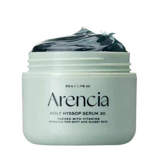 A jar of Arencia Holy Hyssop Serum 30 with a pale mint-green container, dark gel visible at the top, and a translucent mint-green splash behind it on a white background.