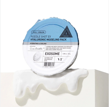 A round container of Cica + Khylon Reedle Shot EX Hyaluronic Modeling Pack, labeled EXOSOME, shown on a white surface with a white modeling cream smear in front. Visible brands include Cica + Khylon and VT.