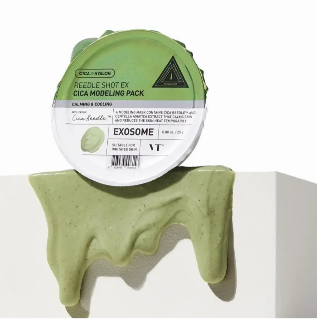 A round cosmetic product labeled 'REEDLE SHOT EX CICA MODELING PACK' with a white and green lid, shown resting on a white pedestal with pale green cream dripping from the bottom. The brand 'Cica Needle' is visible on the label.