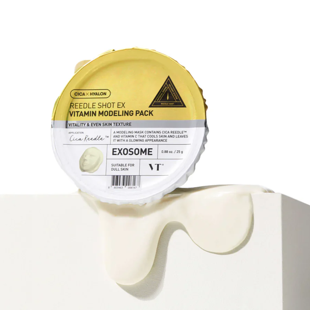 A round cosmetic jar labeled 'DICA X HYALON REEDLE SHOT EX VITAMIN MODELING PACK' with a yellow lid and white base, shown on a white pedestal with cream dripping below. The brand VT is visible on the label.